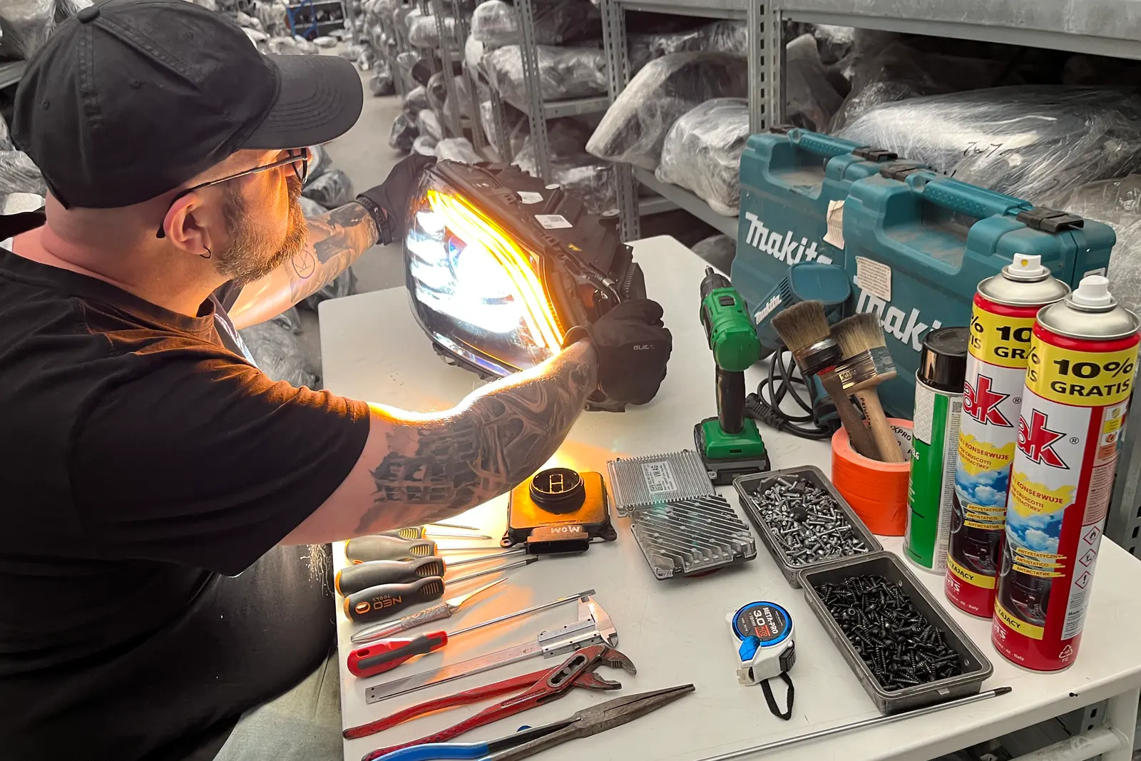 A technician checking the dipped beam on a headlight