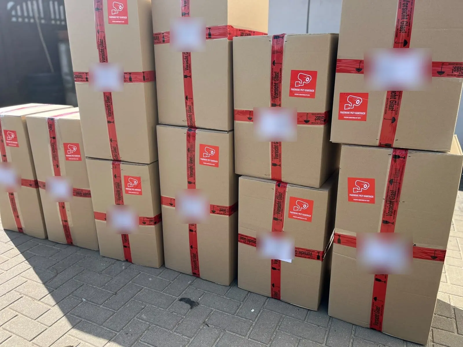 A stack of packed ILUMI parcels ready to ship